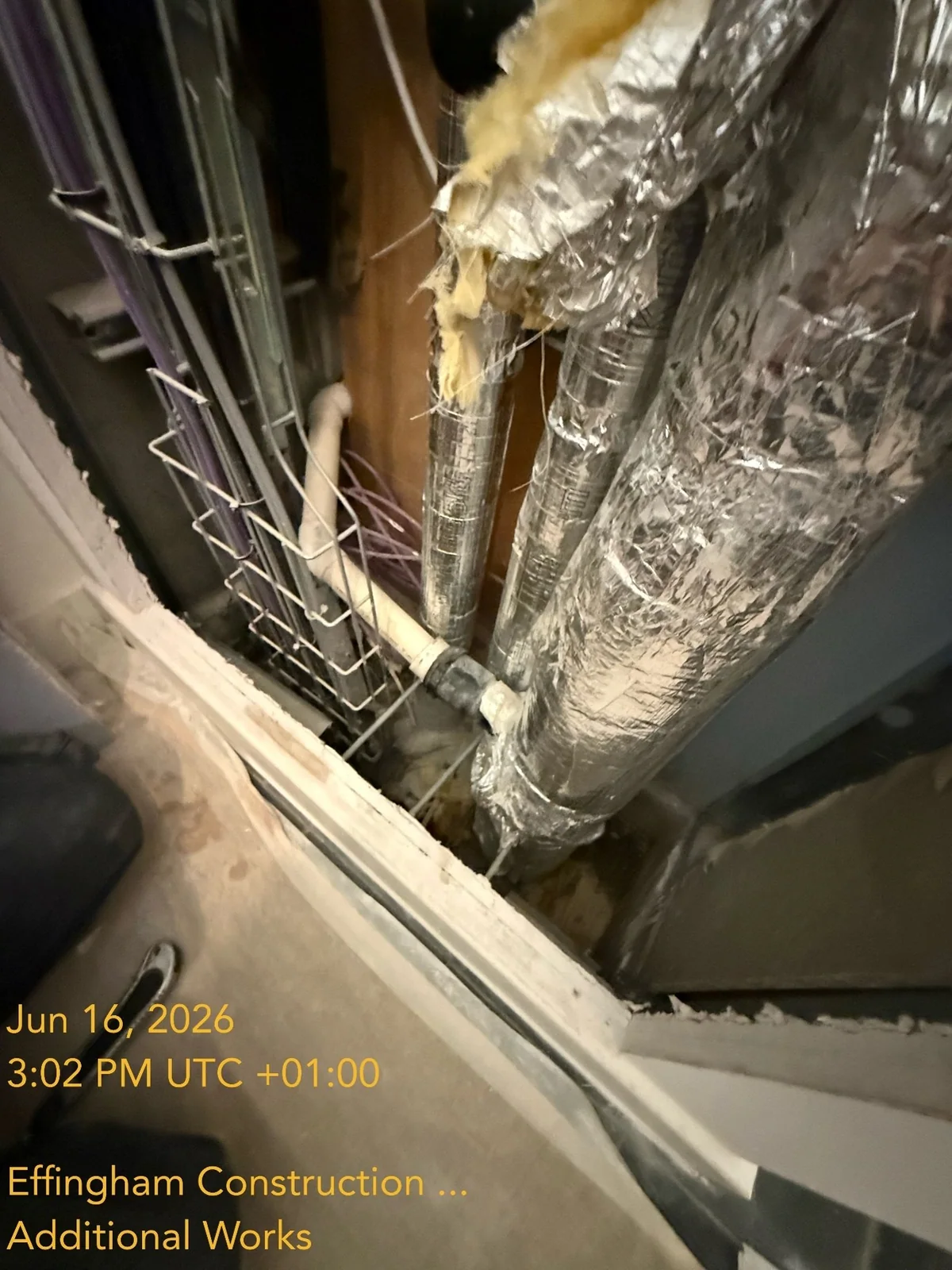 Service void and wastewater pipework at Dockley Apartments during leak repair