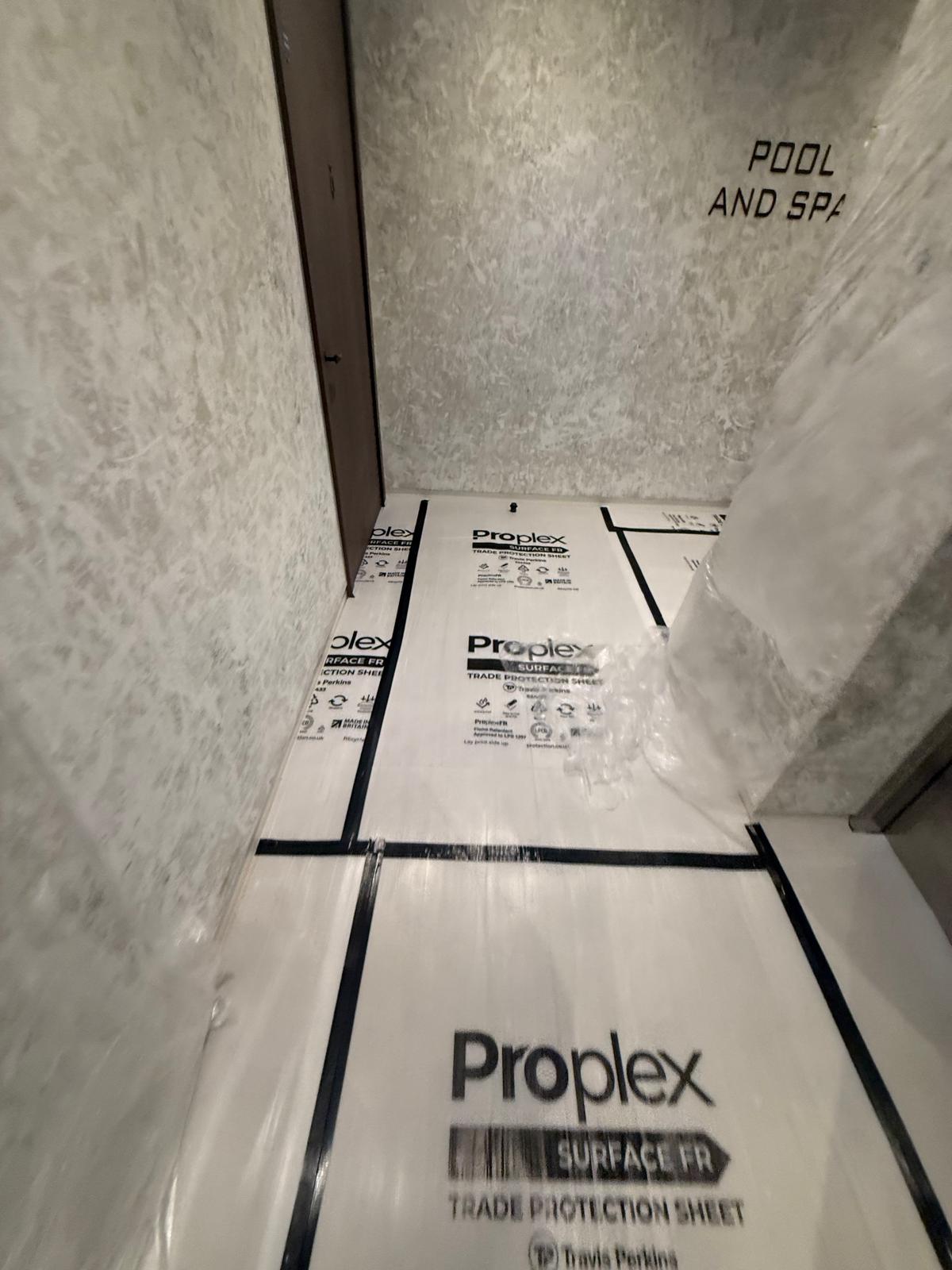 Protected floor and pool and spa entrance during ceiling works in Nine Elms, London