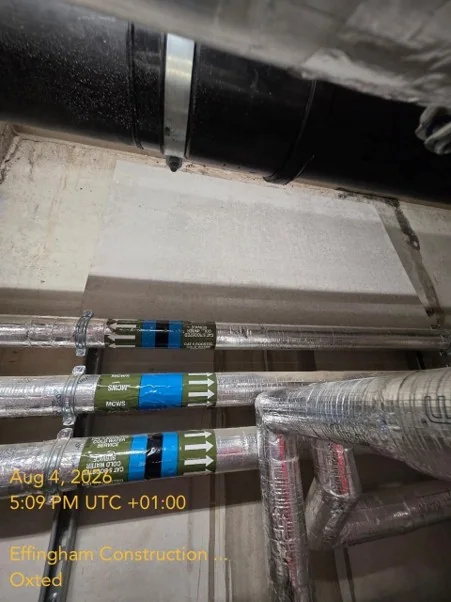 Pipework and tank-room wall during remedial work in Oxted