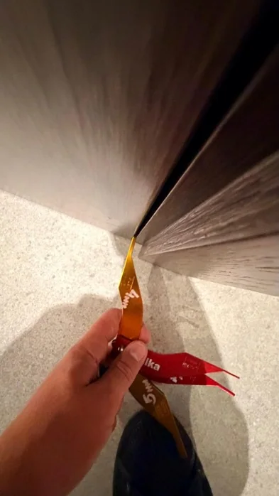Checking the gap at a communal fire door during POWD works